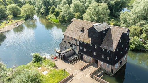 An aerial photo of Houghton Mill and the water taken in summer